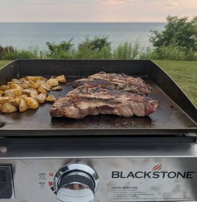 Blackstone griddle with steak and potatoes