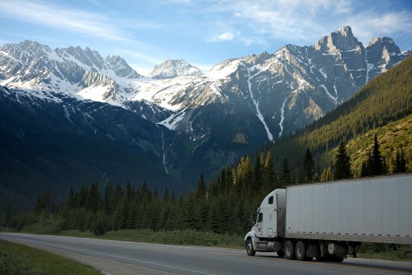 semi truck driving on mountain road
