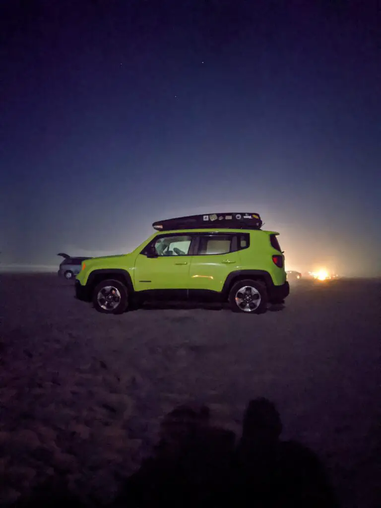 Green jeep- our RV tow vehicle parked on the beach