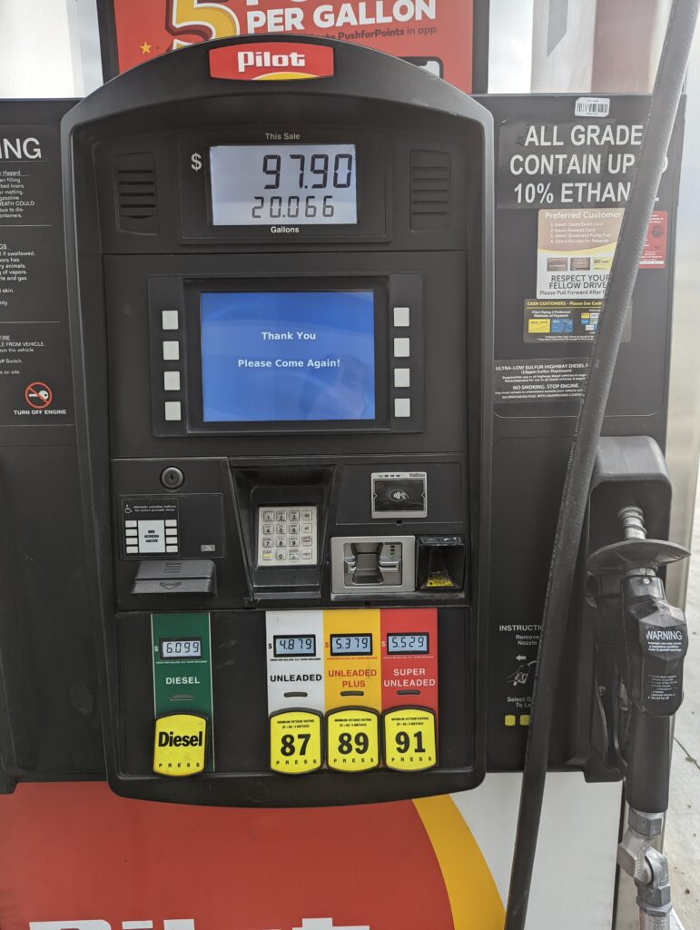 gas pump showing 97.90 for just over 20 gallons of regular unleaded fuel