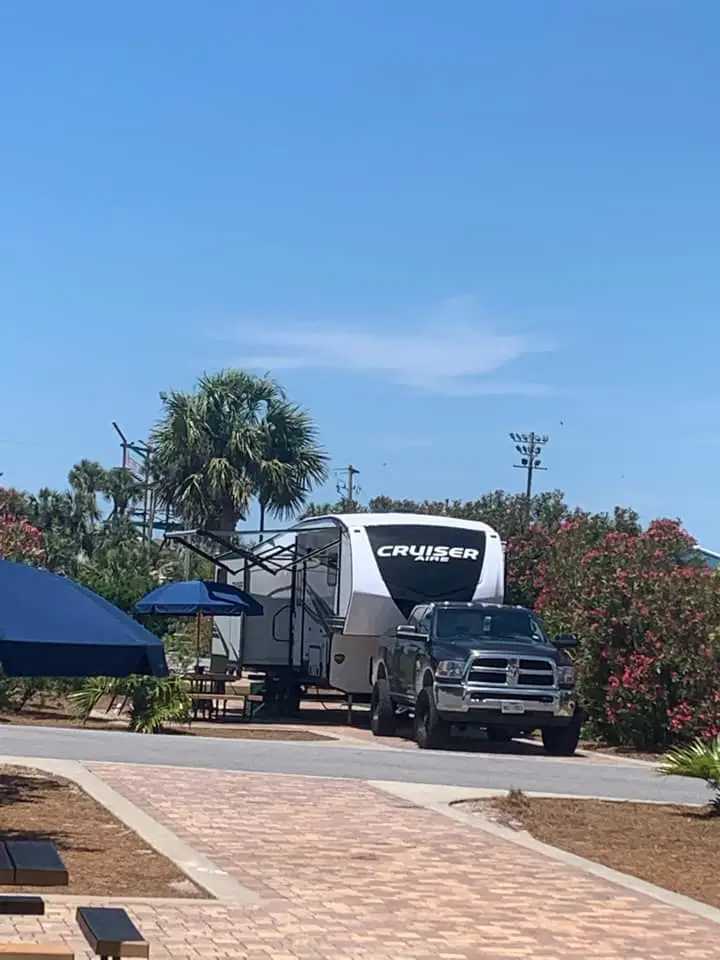 Destin West RV campsite in Florida. Beautiful brick sites with a fifth wheen and truck pictured at a site